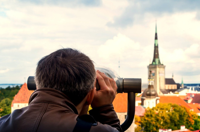 Anonymous,Tourist,Looking,Through,Observation,Binocular,Glasses,In,Tallinn.